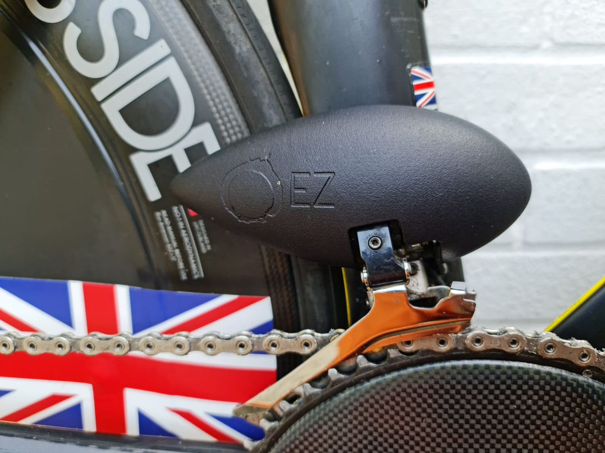 Black aerodynamic chainring guard on a triathlon bike drivetrain