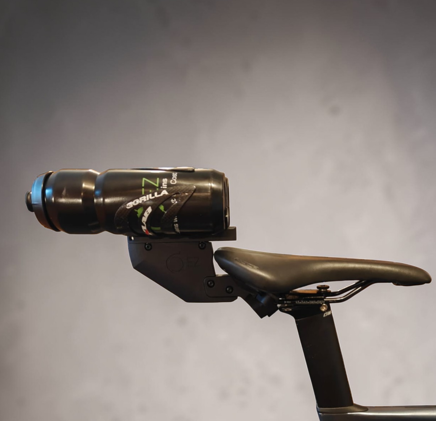 Aerodynamic rear triathlon bike bottle holder mounted behind the saddle.
