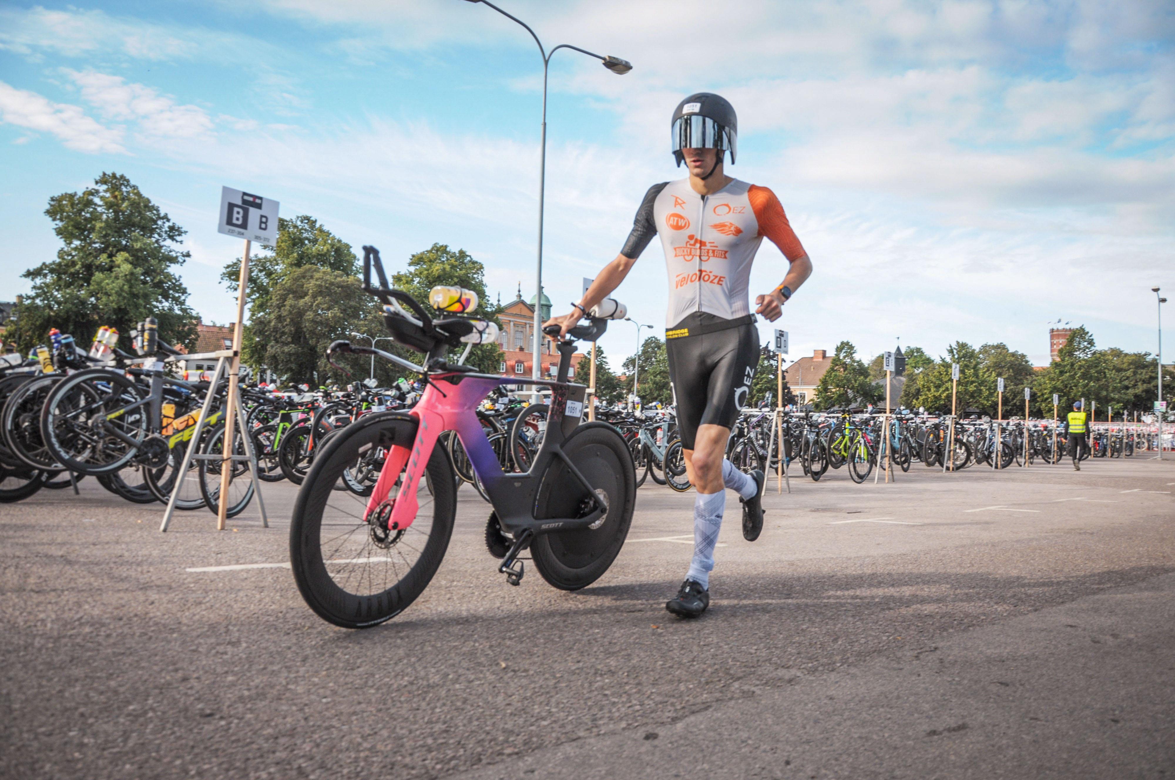 Man races in ironman with disc wheel and rear bottle mount holder