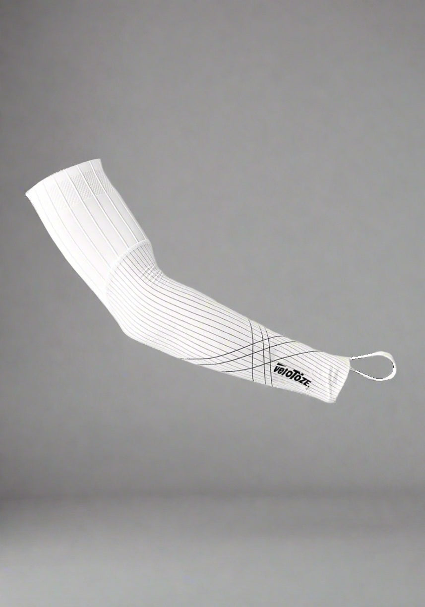 White cycling arm sleeve with black geometric lines, elastic cuff, and veloToze logo