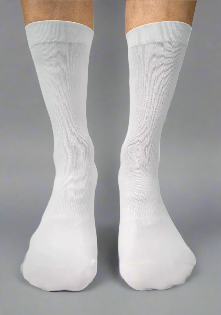 Front view of two legs wearing plain white knee-high cycling socks on a gray background