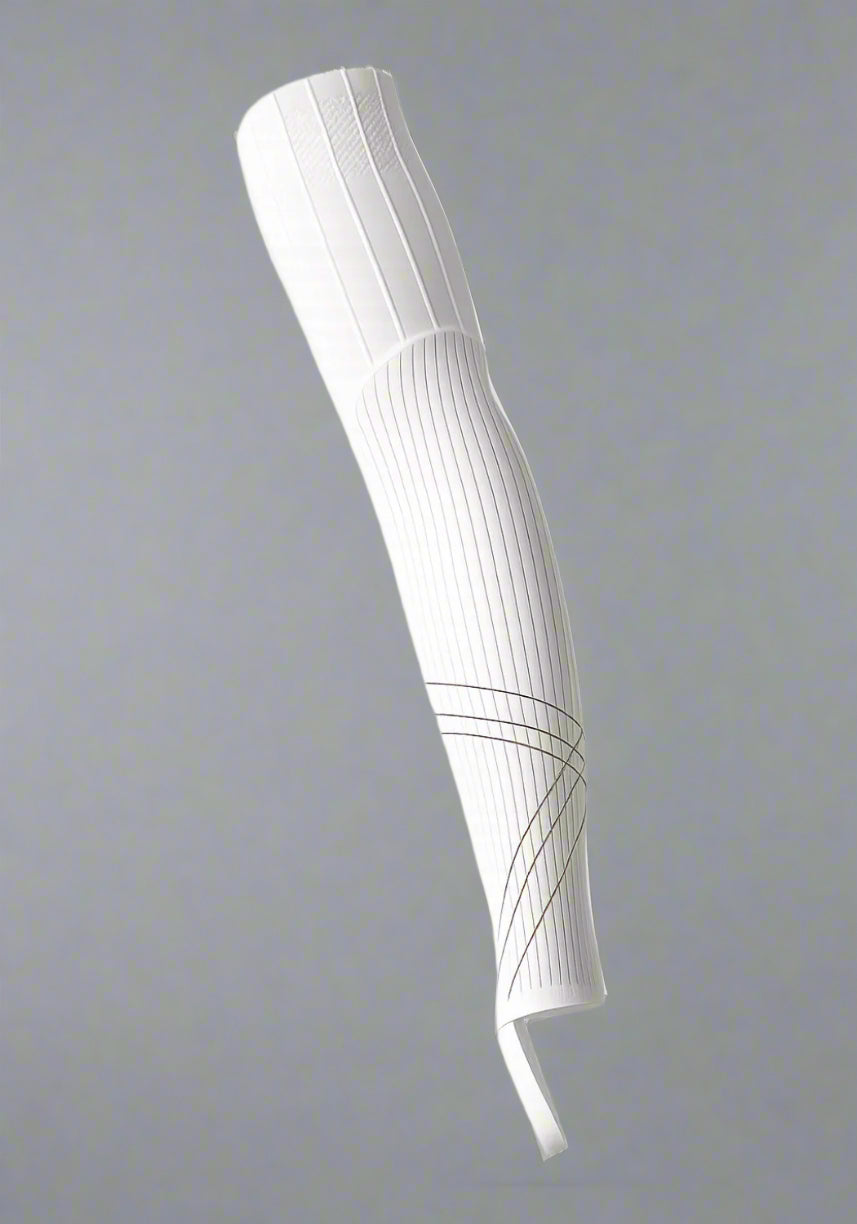 White aerodynamic cycling leg sleeve with ribbed texture on a neutral background