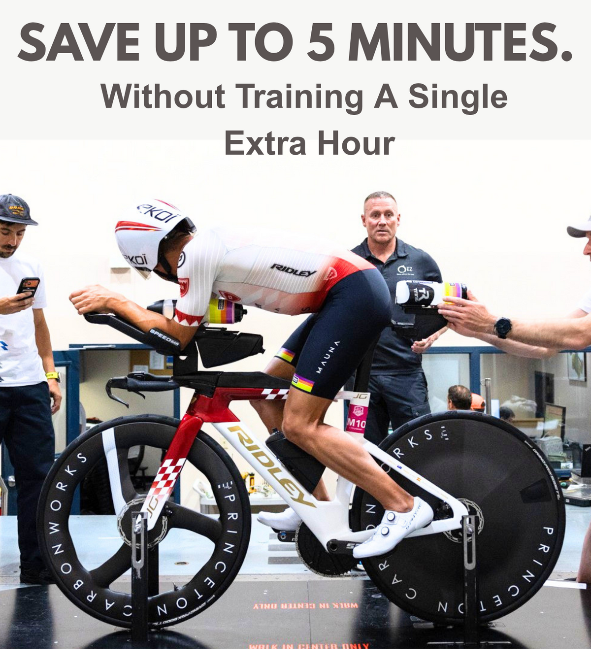 Triathlon athlete on a Ridley bike with disc wheel covers in a wind tunnel testing setup.