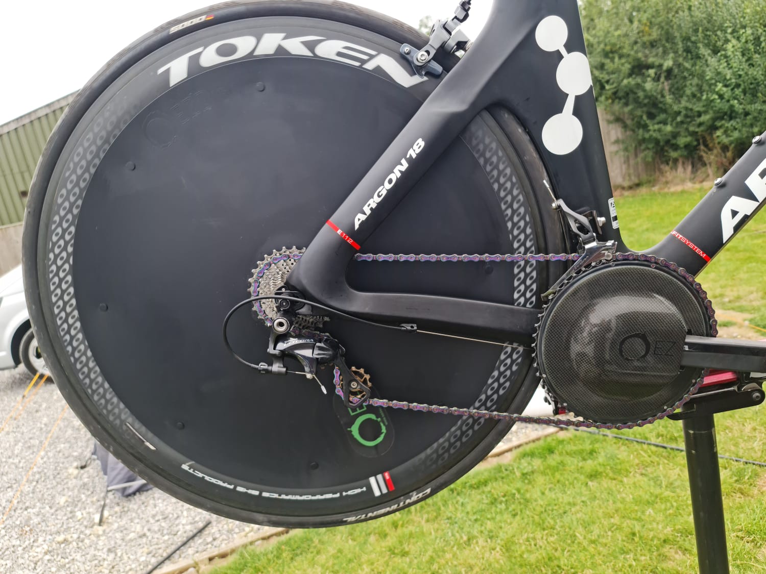 Argon 18 triathlon bike with Token disc wheel and aerodynamic drivetrain components.