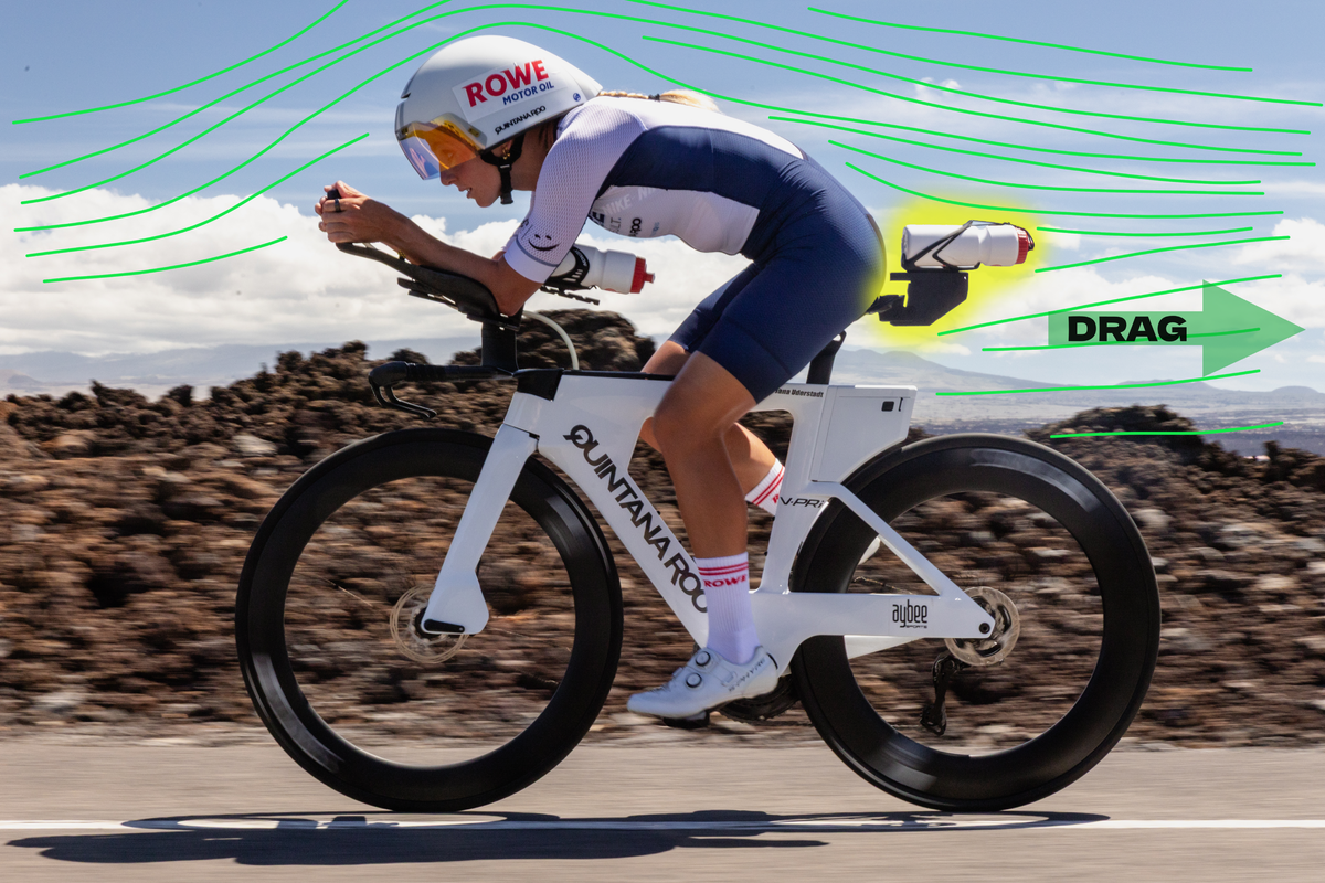 Triathlete riding an aerodynamic disc wheel bike with airflow drag visualization.