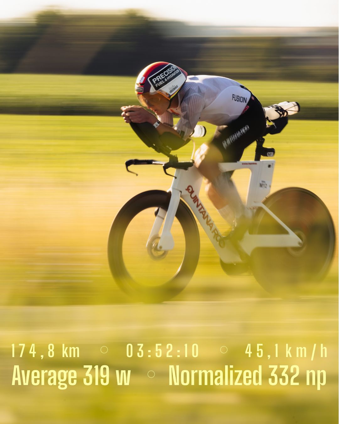 Triathlete riding a white aero bike with disc wheels on a sunny road.