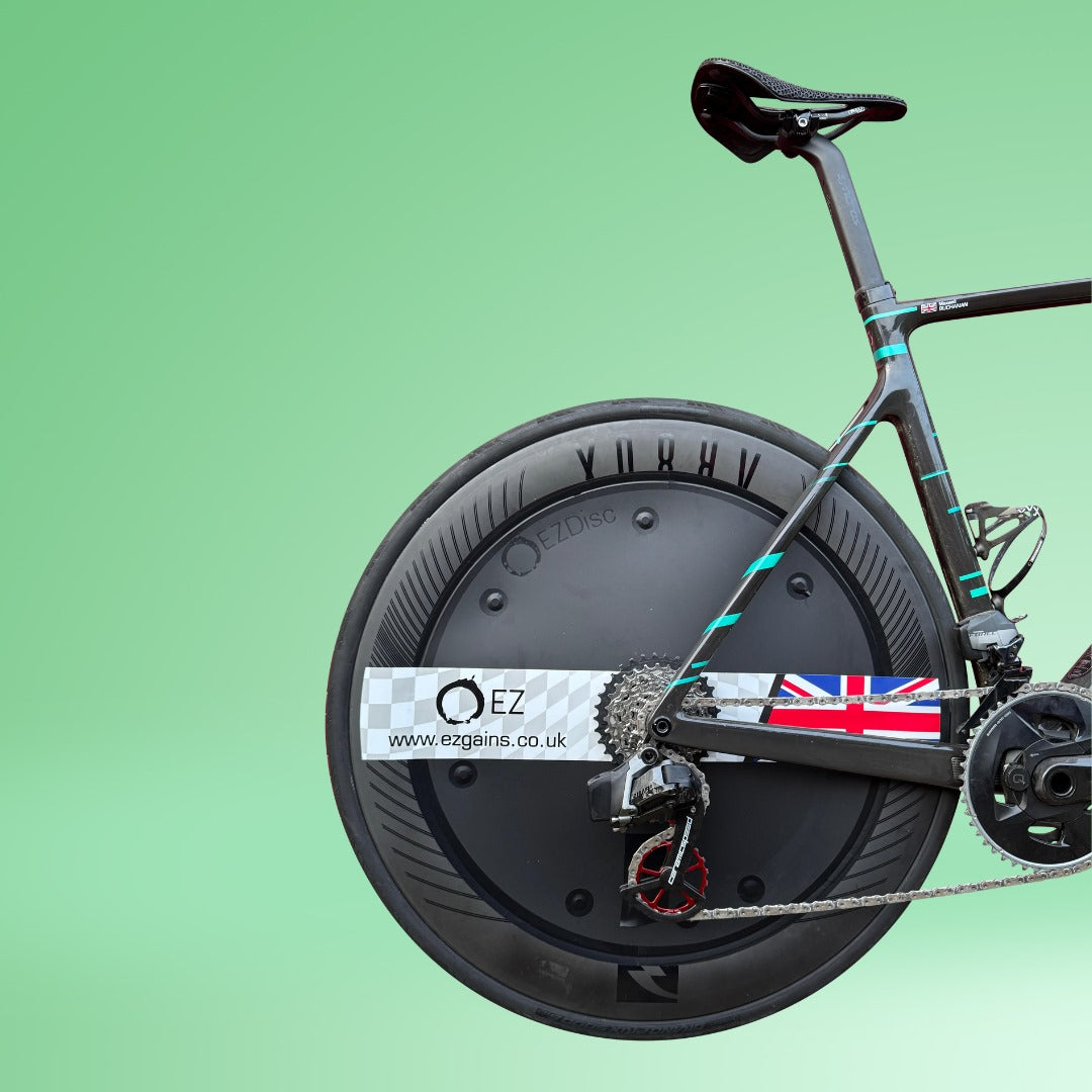 Aerodynamic triathlon disc wheel cover with EZDisc branding on a racing bike.