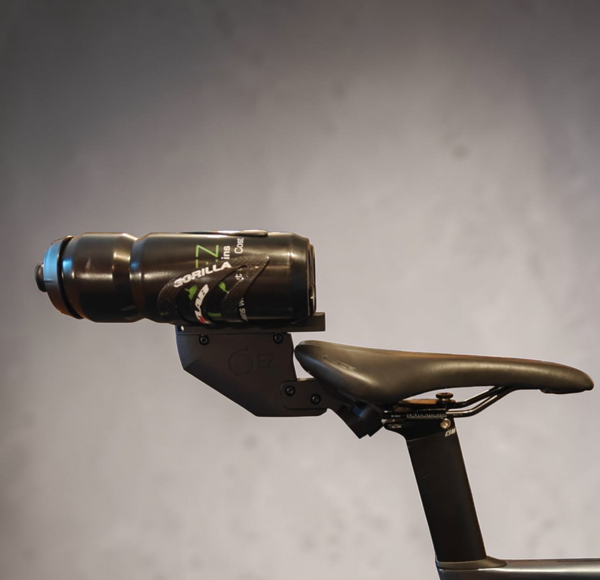 Aerodynamic rear triathlon bike bottle holder mounted behind the saddle.