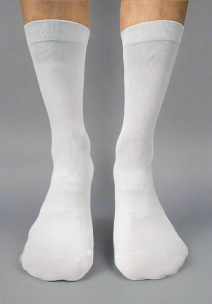 Front view of two legs wearing plain white knee-high cycling socks on a gray background