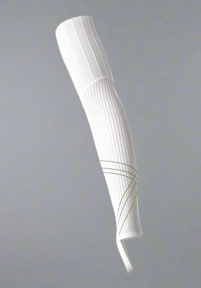 White aerodynamic cycling leg sleeve with ribbed texture on a neutral background