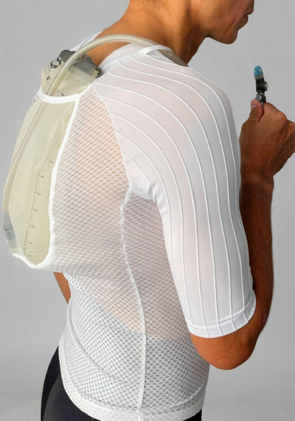 Cyclist wearing white mesh jersey with integrated hydration pack and drinking tube
